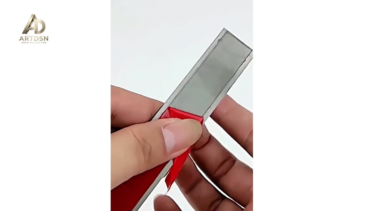 Peeling off the red backing from flat bar trim