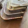 Stainless steel trim being bent into a curved shape