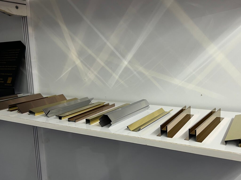 ARTDSN stainless steel trim samples in gold, bronze, and silver finishes