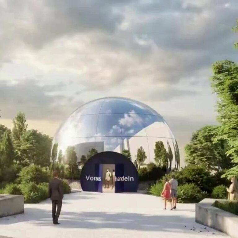 Spherical stainless steel pavilion with 8K mirror-finished double-curvature panels installed in front of a storefront.