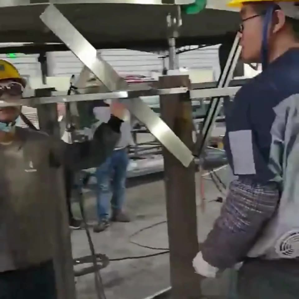 Curved stainless steel plates in workshop