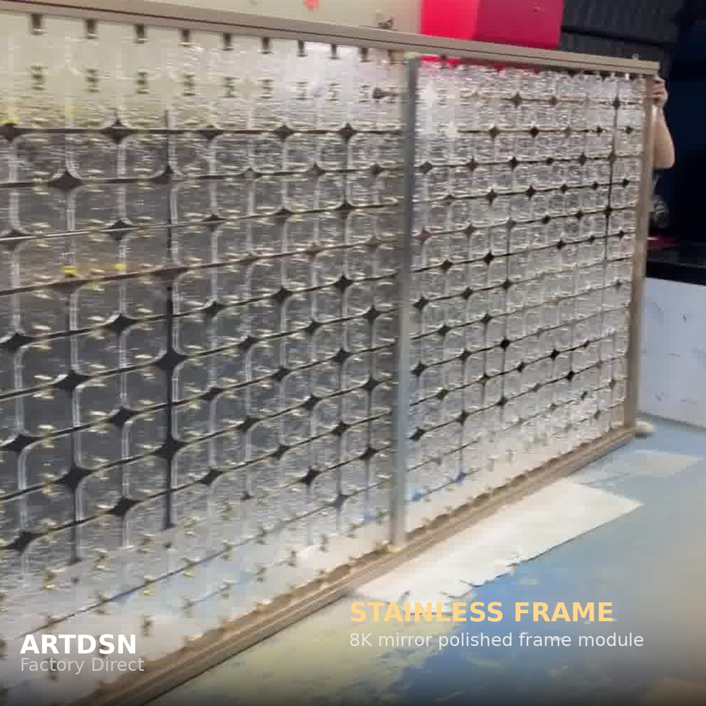 Full-scale stainless steel partition screen standing in the ARTDSN workshop, ready for shipment
