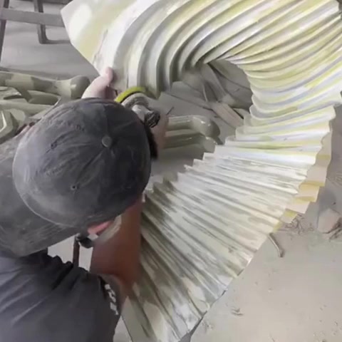 Assembling the welded ribs of a twisted ribbon stainless steel sculpture in the workshop