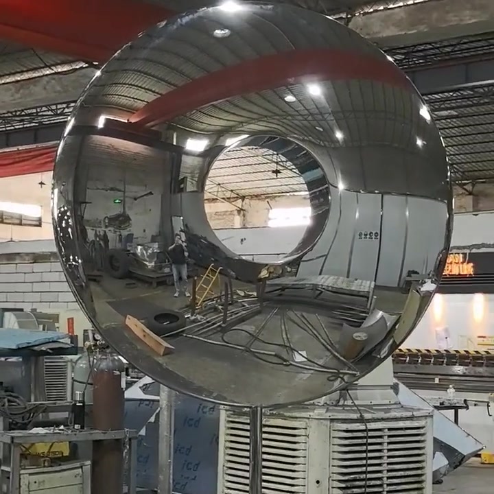 Front view of the completed mirror-polished ring showing a clear undistorted reflection of the factory interior