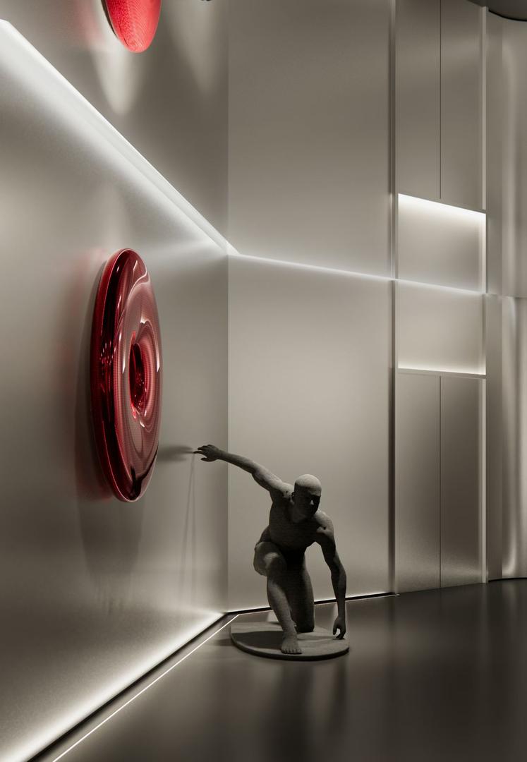 Glossy red nano paint torus wall sculpture in a brushed stainless steel showroom beside a grey stone finish figure sculpture